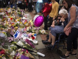 Women cry after placing flowers in a square in central Manchester, Britain, Wednesday, May 24, 2017, after the suicide attack at an Ariana Grande concert that left more than 20 people dead and many more injured, as it ended on Monday night at the Manchester Arena. (AP Photo/Emilio Morenatti)